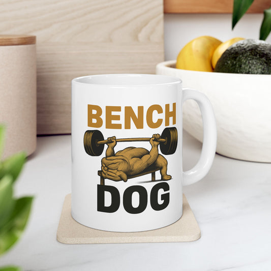 Person holding a mug with a dog Bench Dog gym humor graphic.