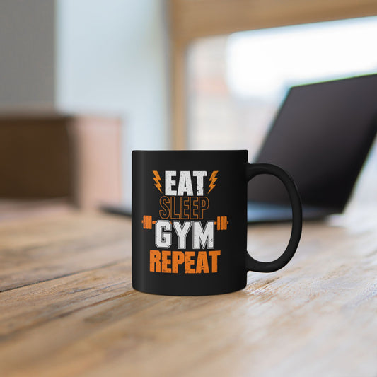 Person holding a mug with Eat Sleep Gym Repeat weightlifting graphic.