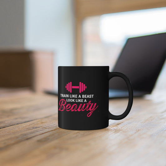 Woman holding a mug with Train Like a Beast Look Like a Beauty gym text.