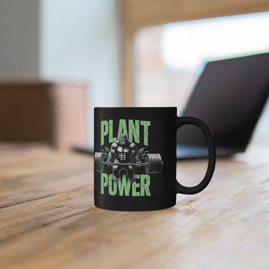 Person holding a black mug with Kale Yeah vegan gym humor graphic.