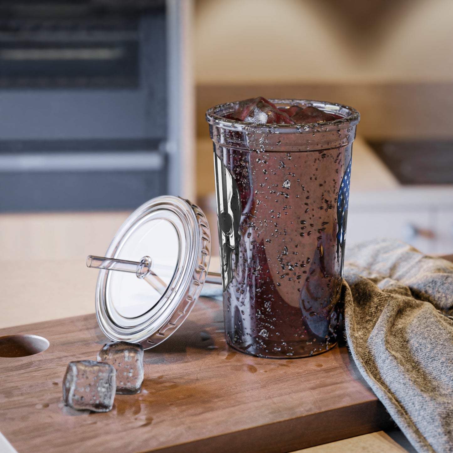 Glass of iced coffee with a lid on a wooden surface