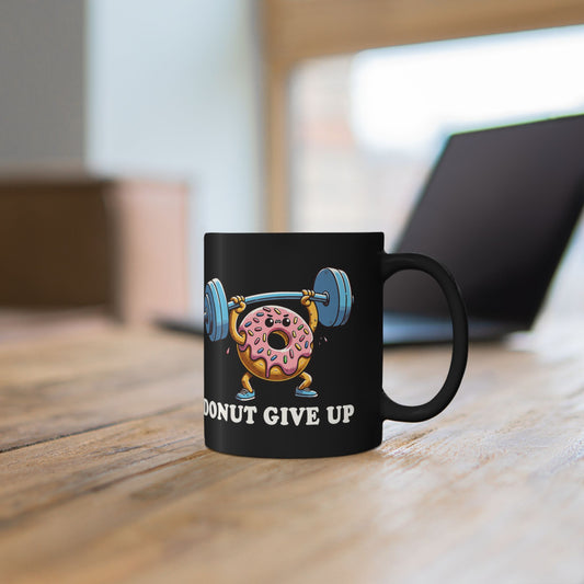 Person holding a mug with Donut Give Up barbell gym humor graphic.