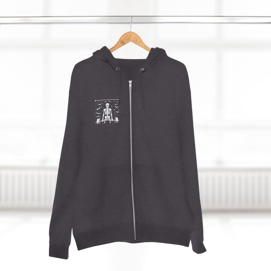 Black hoodie with a zipper on a hanger against a white background