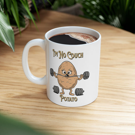 Person holding a mug with I'm No Couch Potato sarcastic gym graphic.