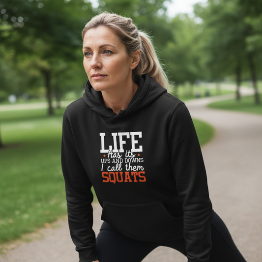 Woman wearing a black hoodie with a humorous quote in a park