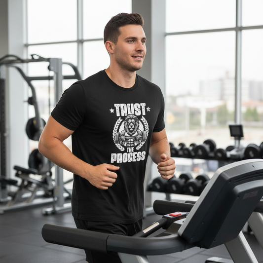 Person wearing a black t-shirt with a lion Trust The Process gym motivational graphic.
