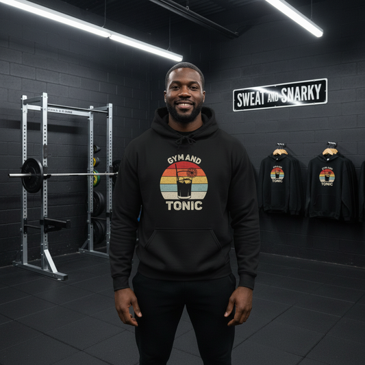 Person wearing a black hoodie with 'Gym and Tonic' design in a gym setting.
