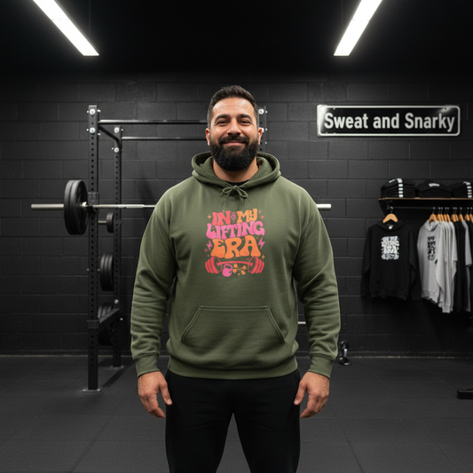 Man wearing a green hoodie with colorful text in a gym setting