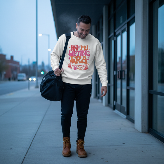Man walking outdoors holding a bag, wearing a sweatshirt with text and graphics.