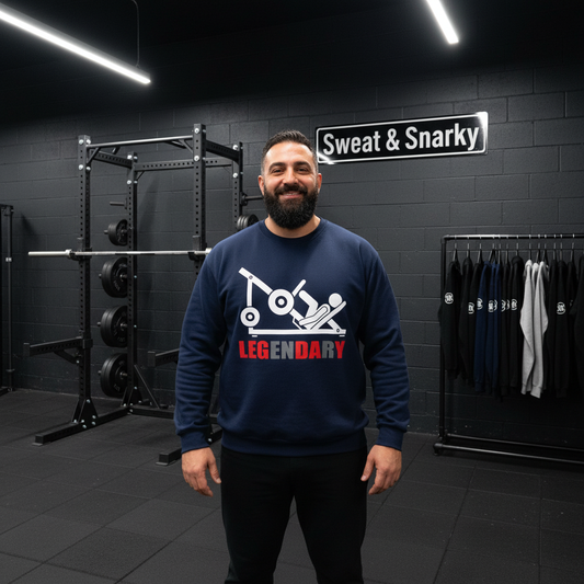 Man wearing a navy blue sweatshirt with 'Legendary' graphic in a gym setting.