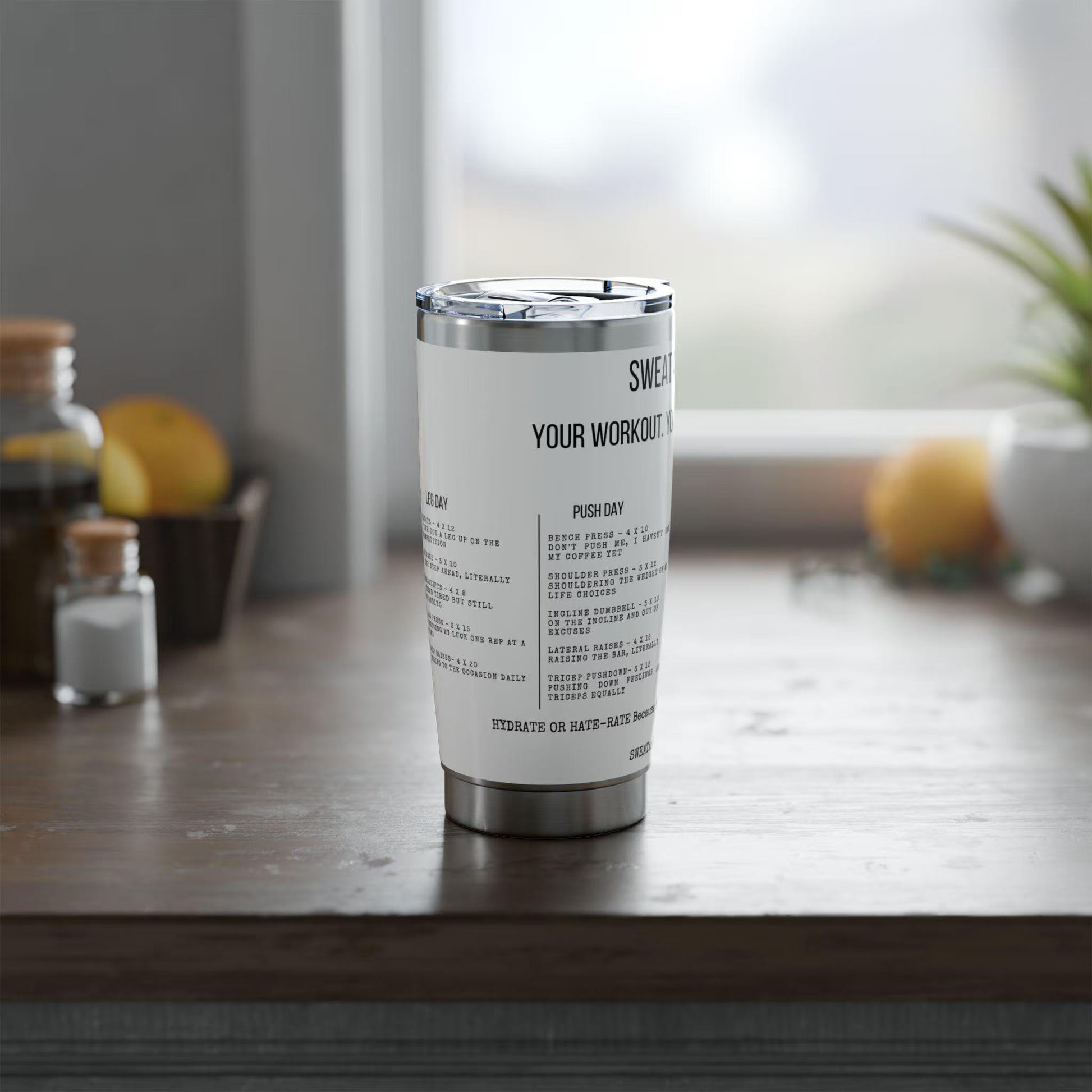 Tumbler with text on a wooden surface with a blurred background